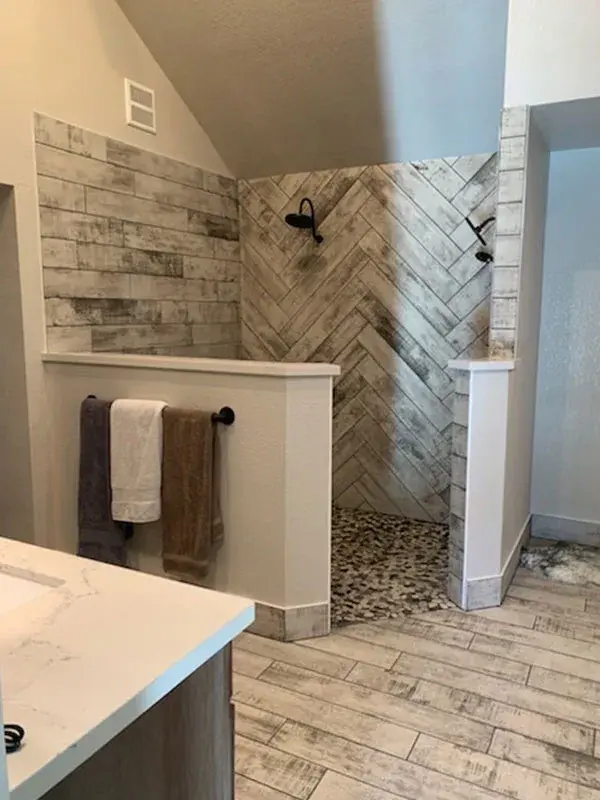 Bathroom project by Barron's Flooring & Home in Placerville, CA featuring Wood-look plank porcelain tile, Natural stone pebble mosaic, Wood-look plank porcelain tile