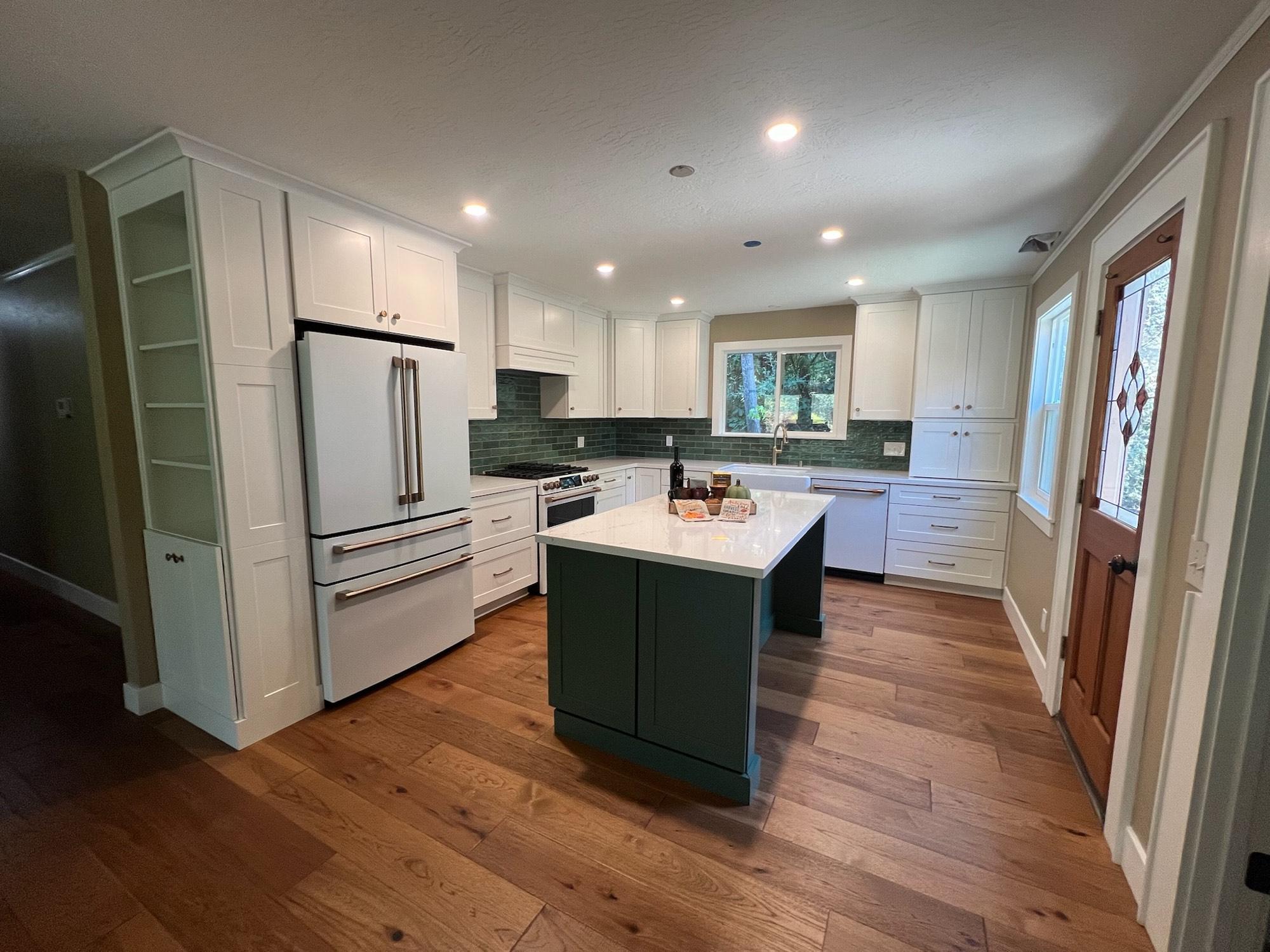 Remodeled kitchen with hardwood floors by Barron's