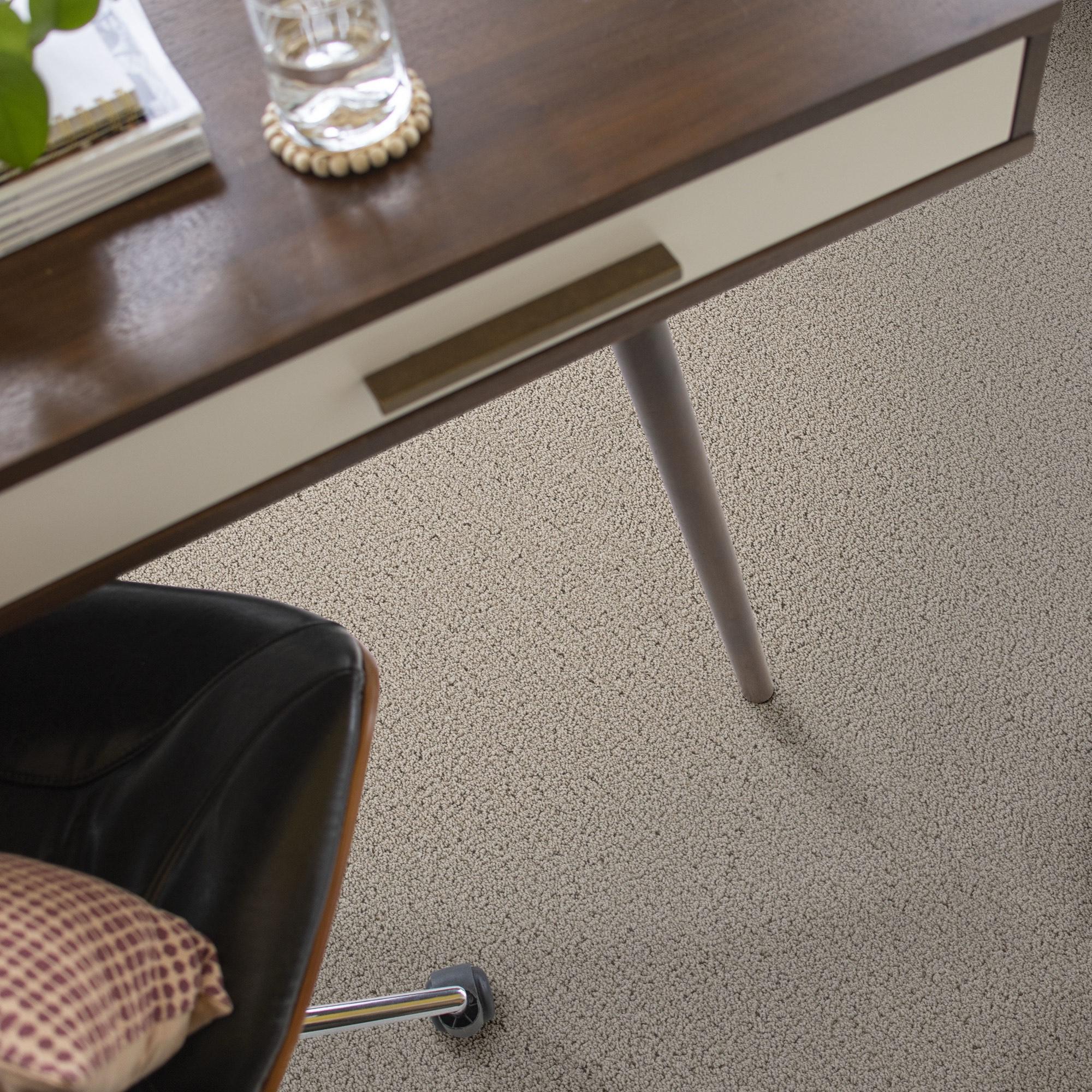 Close-up of Shaw Floors Intricate Trace frieze carpet beneath a desk and chair